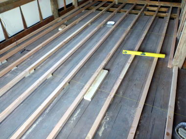 セルフリフォーム床作り作業（新たに根太を敷き、水糸を張って高さを水平に調整している）